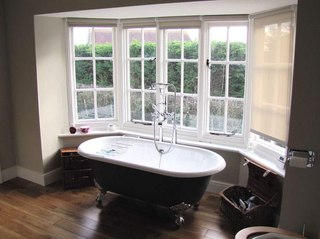 Freestanding bath below a window